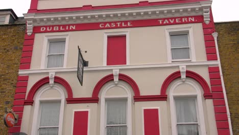 Low-angle-shot-of-most-famous-historic-Dublin-castle-tavern-pub-in-Camden,-London,-UK-on-a-cloudy-day