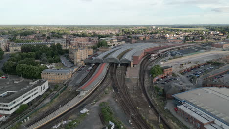 Front-On-Pullback-Aerial-Drone-Shot-of-York-Railway-Station-and-York-Royal-Mail-Office-in-Shot-on-Sunny-and-Cloudy-Evening---North-Yorkshire-UK