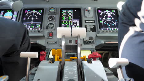 Pilots-Inside-Aircraft-Cockpit-With-Controls-And-Instrument-Panel-During-Flight