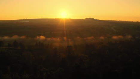 Aerial-Drone-Shot-Flying-Backwards-Revealing-Misty-Stunning-Sunrise