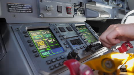 Pilot-Tuning-The-RMU-On-The-Cockpit-Of-An-Aircraft