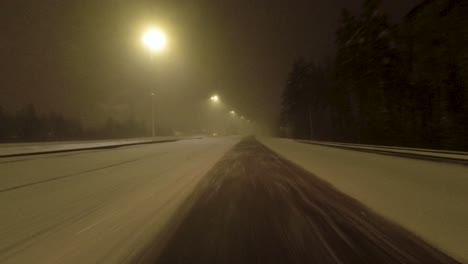 POV-shot-driving-alone-along-a-snow-covered-highway-in-Helsinki