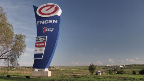 Commercial-highway-trucks-and-big-Engen-petrol-station-sign,-S-Africa