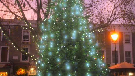 Glowing-Christmas-Tree-Decorated-In-The-Famous-Town-Of-Notting-Hill-In-West-London,-England