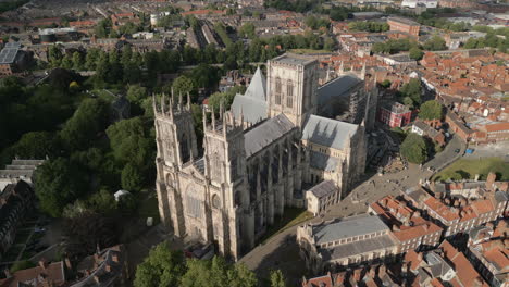 High-Rotating-Aerial-Drone-Shot-Around-York-Minster-Old-Cathedral-in-York-City-Centre-with-Trees-and-Old-Buildings-Around-North-Yorkshire-United-Kingdom