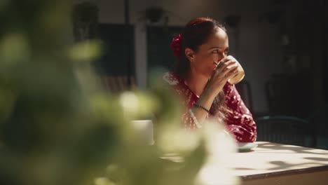 Schöne-Indische-Frau,-Die-Kaffee-Trinkt,-Morgens-Draußen-Sitzt,-Mit-Einem-Verträumten-Und-Glücklichen-Blick,-In-Fontainhas,-Indien