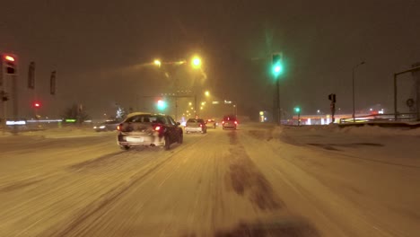 Slow-POV-shot-driving-with-heavy-traffic-on-a-snow-covered-highway-in-Helsinki