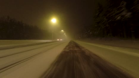 POV-shot-driving-along-an-empty-highway-with-a-cleared-lane-in-Helsinki