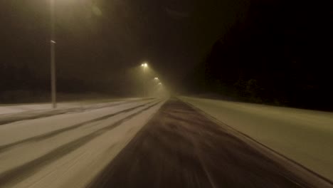 POV-shot-driving-along-a-snow-covered-highway-in-Helsinki-with-no-other-drivers