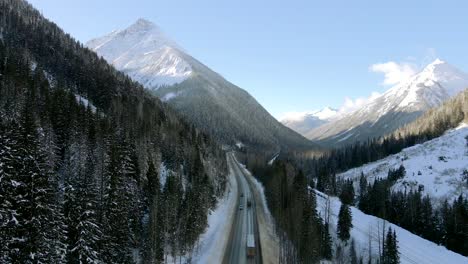 Winter-Road-Trip-on-Trans-Canada-Highway-1:-Cars-and-Trucks-Surrounded-by-stunning-Mountains-in-British-Columbia,-Canada