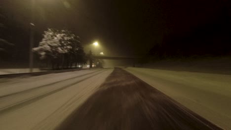 POV-traveling-shot-along-a-quiet-snow-covered-highway-in-Finland