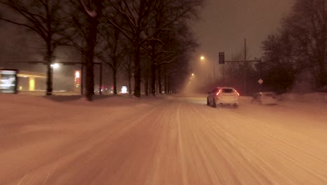 POV-driving-shot-alongside-other-road-users-in-a-snowstorm-in-Helsinki