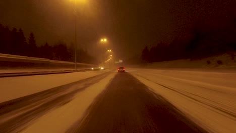 POV-shot-driving-along-a-lane-that-has-been-created-in-the-snow-on-a-highway