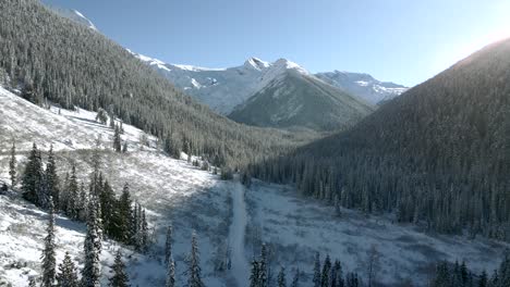 Winter-Wonderland:-Aerial-View-of-Majestic-Forests-and-Snow-Capped-Rocky-Mountains-in-Revelstoke,-British-Columbia