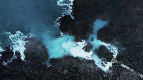 Vibrant-blue-geothermal-water-run-off-into-Atlantic-Ocean,-Reykjanes-Power-Plant