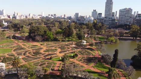 Aerial-orbiting-shot-of-beautiful-Rosedal-Park-with-Lake-and-skyline-of-Buenos-Aires-in-background
