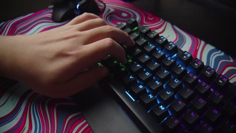 Close-up-of-hand-pressing-RGB-gaming-keyboard-with-dynamic-camera-movement