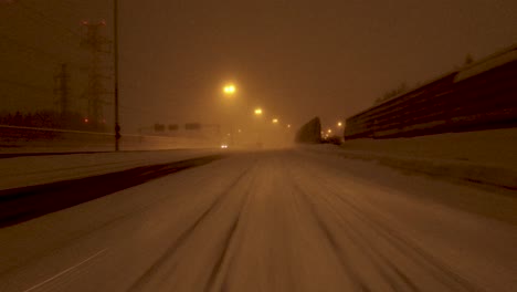 POV-shot-traveling-along-an-empty-highway-with-reduced-visibility-due-to-the-snow