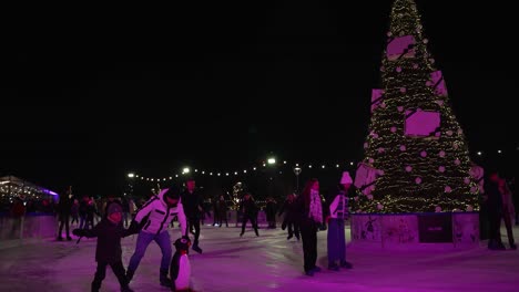 9-December-2022---People-Skating-Around-Christmas-Tree-At-Glide-Battersea-Ice-Rink-At-Night