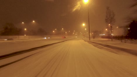 POV-shot-merging-onto-a-snowy-highway-in-Helsinki,-Finland