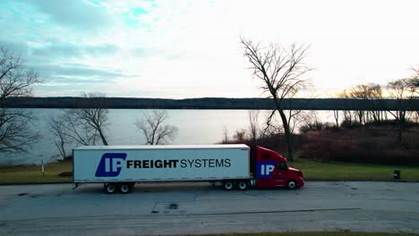 epic-aerial-of-semi-truck-parked-in-saganashkee-slough-woods,-willow-springs-Illinois,-usa