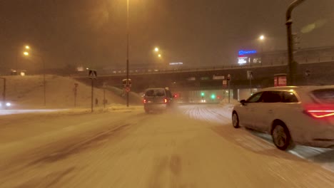 POV-driving-shot-under-a-bridge-and-through-downtown-Helsinki-in-a-snow-storm