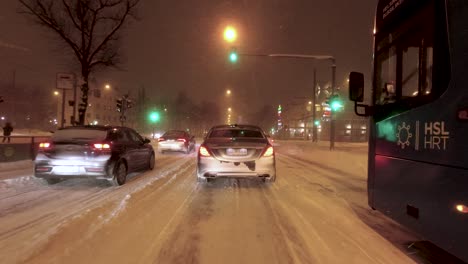 POV-shot-of-cars-stopped-at-traffic-lights-whilst-it-is-snowing-in-Helsinki