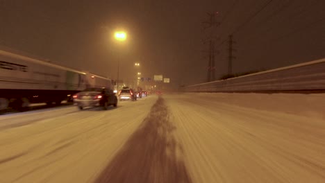 POV-shot-driving-past-the-very-busy-highway-due-to-the-thick-snowfall-in-Helsinki