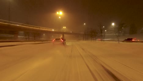 POV-shot-traveling-alongside-other-motorists-on-a-snowy-highway