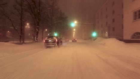 Static-POV-shot-of-cars-driving-through-a-fully-covered-public-street-in-Helsinki