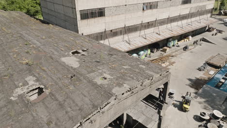 Broken-concrete-roof-of-industrial-warehouse-of-abandoned-factory