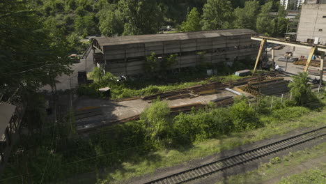Railroad-track-and-abandoned-lumberyard-warehouse-in-Chiatura,-Georgia