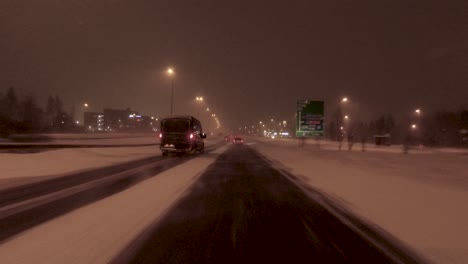 POV-shot-driving-along-a-snow-covered-highway-in-Helsinki,-Finland
