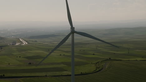 Rotating-blades-of-wind-turbine-generator-above-Gori-fields-in-Georgia