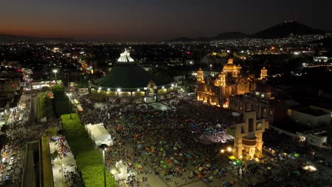 Aerial-view-over-believers-on-the-Plaza-Mariana-at-the-Basílica-de-Guadalupe,-late-on-the-Pilgrimage-Virgin-Day-in-Mexico