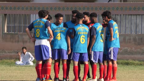 Local-Football-Team-Talking-Amongst-Each-Other-On-Pitch-At-Karachi,-Pakistan
