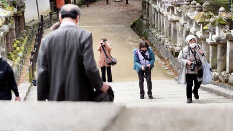 Tourists-Walking-Over-Bridge-and-Taking-Photos-in-Nara,-Japan