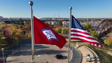 Arkansas-state-and-USA-flag-on-sunny-day-during-golden-hour-light