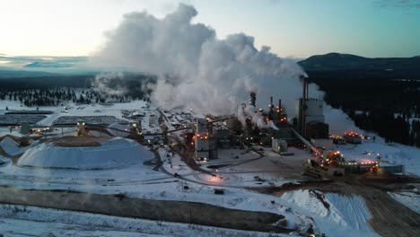 Winter-Morning-at-Pulp-Mill-in-Cranbrook,-British-Columbia:-Aerial-View-of-Industrial-Facility-and-Specialized-Machinery-Transforming-Timber-into-Wood-Pulp