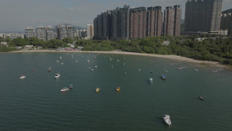 Aerial-Drone-shot-of-tourism-Boat-on-the-water-in-the-city-in-Hong-Kong,-China
