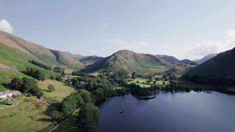 Drone-shot-flying-toward-the-end-of-a-lake-on-a-sunny-day,-Ullswater,-Lake-District,-Cumbria,-UK