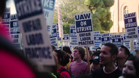 A-Large-Crowd-of-Academic-Workers-Hold-Up-Picket-Signs-and-Listen-to-a-Speaker-at-UCLA