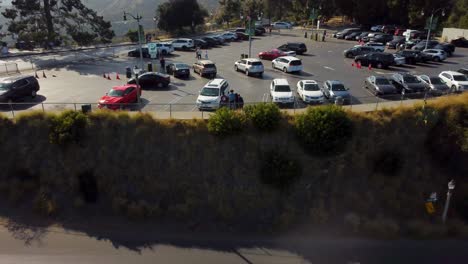 AERIAL:-Backward-moving-drone-shot-of-people-in-the-Hollywood-hills