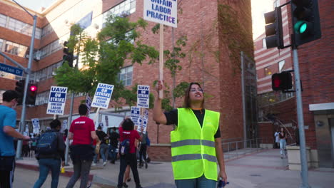 A-Young-Woman-Leader-Chants-and-Raises-a-Picket-Sign-at-the-UC-Academic-Workers-Strike-at-UCLA