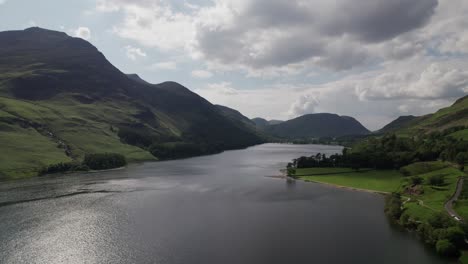 Drone-shot-flying-right-above-Crummock-Water-on-a-sunny-day,-Lake-District,-Cumbria,-UK