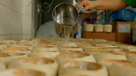The-process-of-making-Coco-Jelly,-a-famous-thai-street-food-made-by-jelly-poured-into-shells-with-shredded-coconut