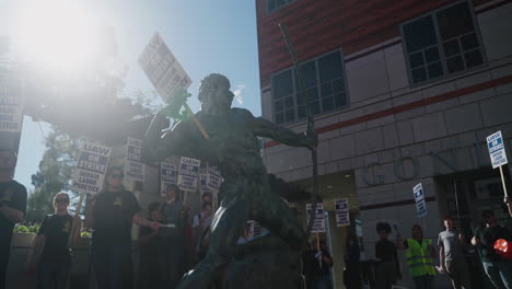 A-Statue-on-UCLA's-Campus-Holding-a-"UAW-On-Strike,"-Sign-Placed-there-by-a-Striking-Academic-Worker