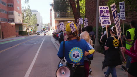 A-Young-Woman-Holding-a-Baby-and-a-Megaphone-Leads-a-Line-of-UC-Academic-Workers-on-Strike-at-UCLA