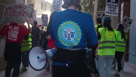 A-Young-Woman-Wearing-a-UAW-5810-Shirt-Marches-at-the-UC-Academic-Workers-Strike-at-UCLA
