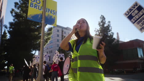 A-Young-Woman-Speaks-into-a-Megaphone-at-the-UC-Academic-Worker's-Strike-Picket-Line-in-UCLA-at-Golden-Hour